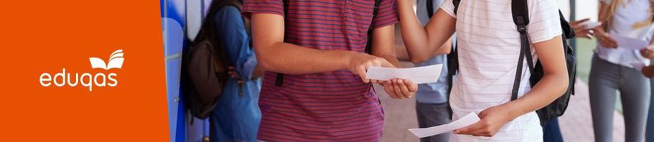 Close-up of two learners holding their results paper.